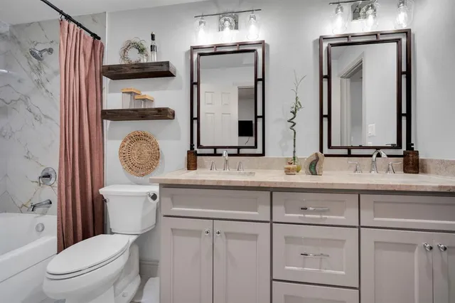 a bathroom with a toilet a sink and mirror