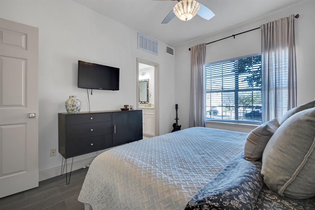 5619 Preston Oaks Road, Unit 802 Dallas, TX 75254 - Photo 21 of 27 a bedroom with a bed and a flat screen tv