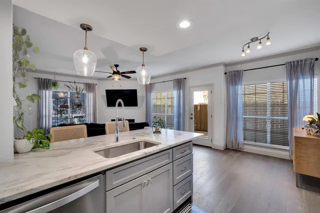 a view of living room with granite countertop furniture a chandelier and wooden floor