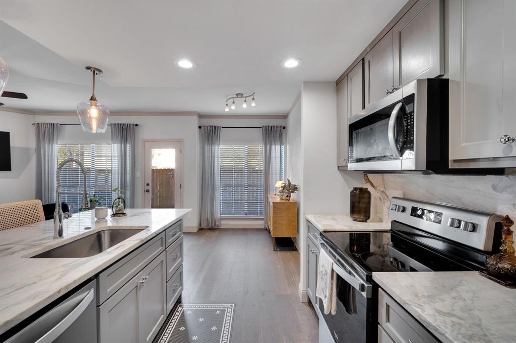 5619 Preston Oaks Road, Unit 802 Dallas, TX 75254 - Photo 10 of 27 a kitchen with stainless steel appliances a sink a stove and cabinets