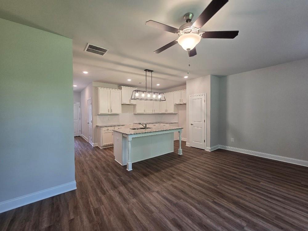 6210 Ripple Way, Unit 90 Atlanta, GA 30349 - Photo 11 of 23 a kitchen with a refrigerator and white cabinets