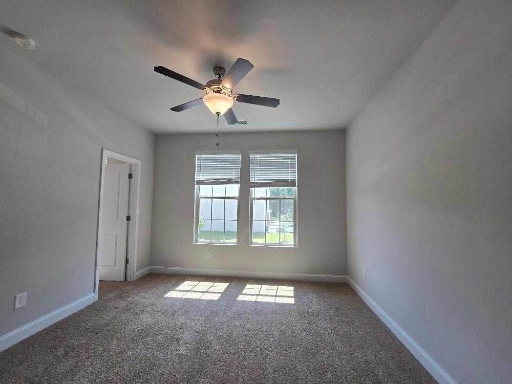 6210 Ripple Way, Unit 90 Atlanta, GA 30349 - Photo 15 of 23 an empty room with a window and a fan
