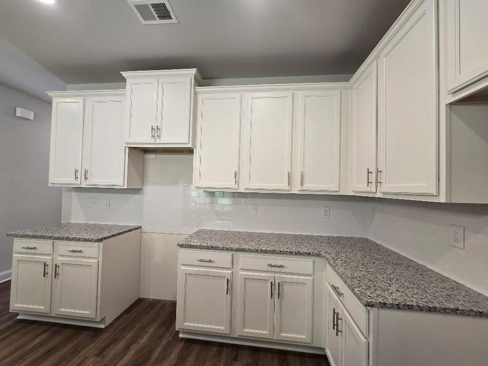6210 Ripple Way, Unit 90 Atlanta, GA 30349 - Photo 4 of 23 a kitchen with granite countertop white cabinets and sink