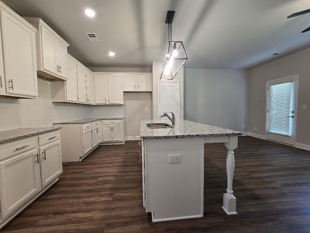 6210 Ripple Way, Unit 90 Atlanta, GA 30349 - Photo 5 of 23 a kitchen with kitchen island a sink stainless steel appliances and cabinets