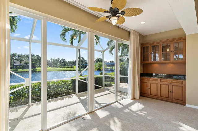a living room with stainless steel appliances granite countertop furniture and a fireplace