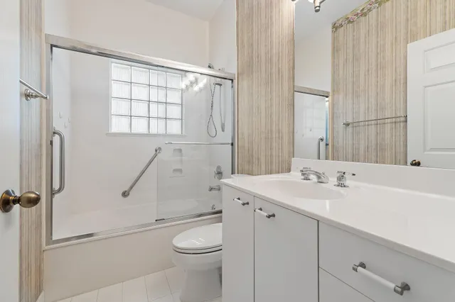 a bathroom with a sink a toilet and a shower