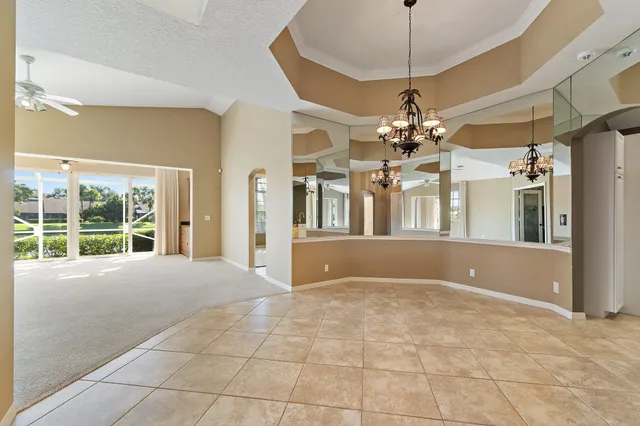 a view of a livingroom with a chandelier furniture and windows