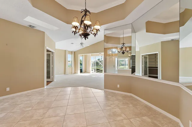 a view of a livingroom with a chandelier furniture and windows