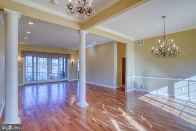 a view of room with a ceiling fan and wooden floor
