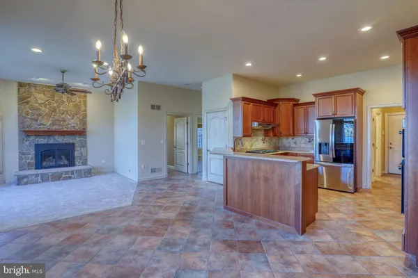 a kitchen with granite countertop a sink and cabinets