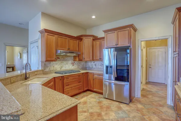 a view of a livingroom with a chandelier fan and wooden floor