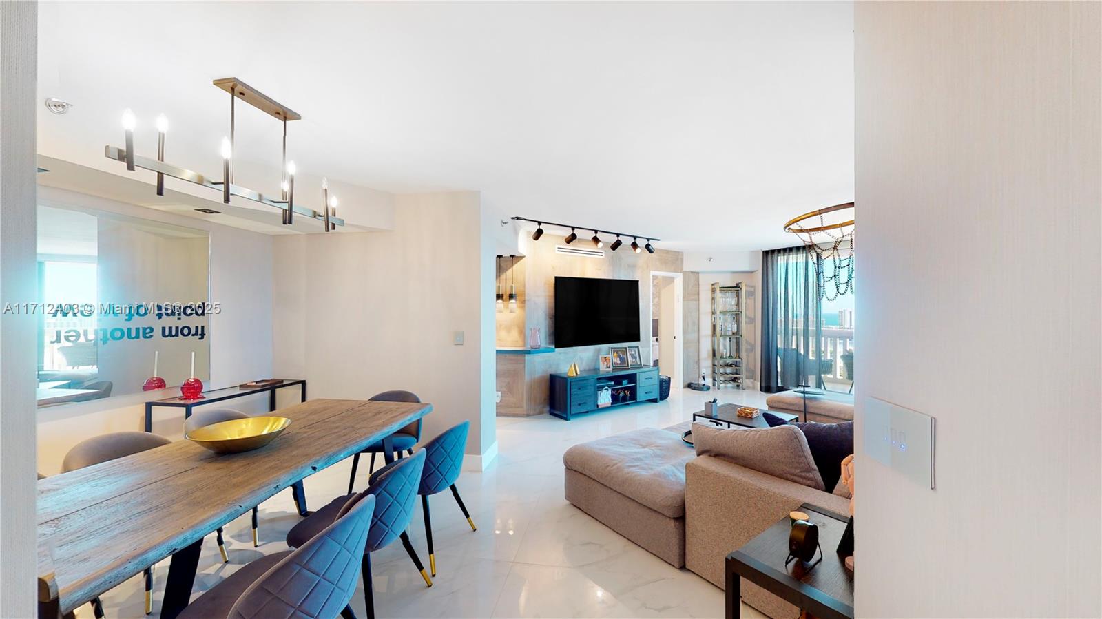 1000 West Island Boulevard, Unit 2903 Aventura, FL 33160 - Photo 3 of 20 a living room with furniture a flat screen tv and kitchen view