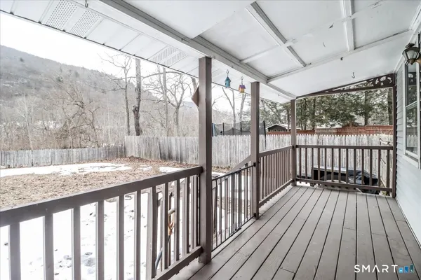 a front view of a house with a yard covered in snow