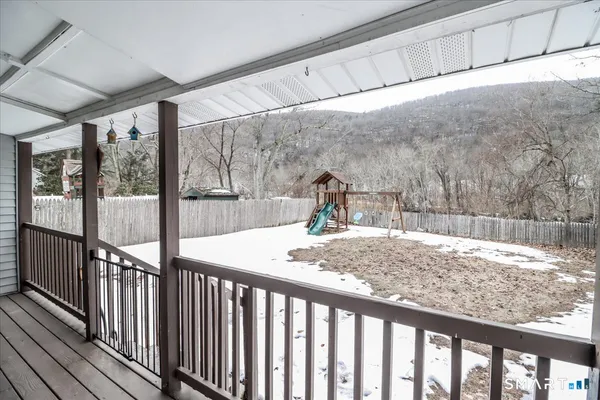 a front view of a house with a yard covered in snow