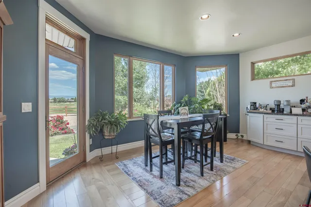a view of a dining room with furniture window and wooden floor