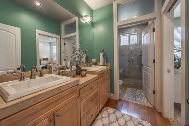 a bathroom with double sink and a mirror