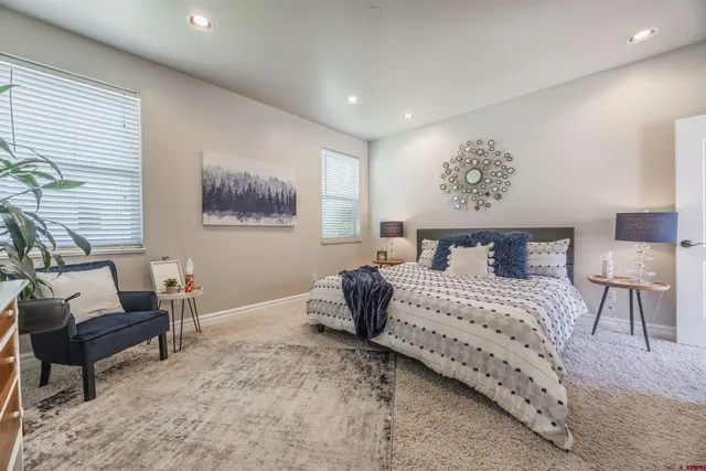 a bedroom with a bed and a painting on the wall