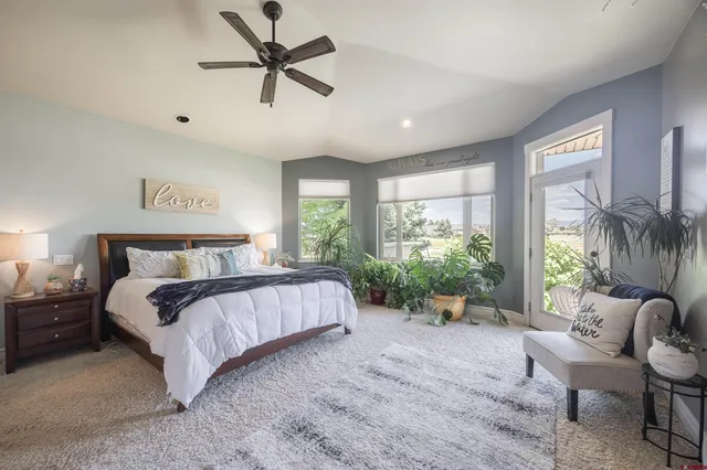 a spacious bedroom with a bed and a large window