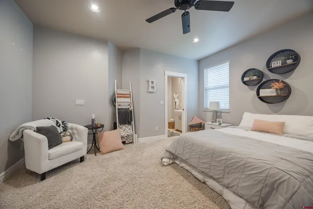a bedroom with a bed and ceiling fan