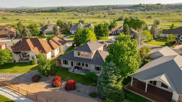 an aerial view of residential houses with outdoor space and ocean view