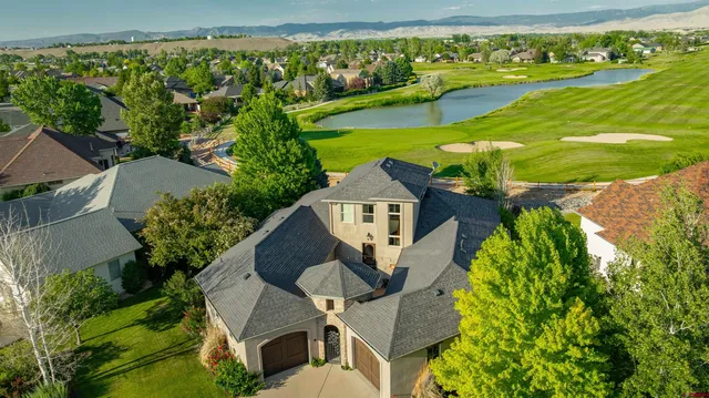 an aerial view of a house with garden space ocean and mountain view in back