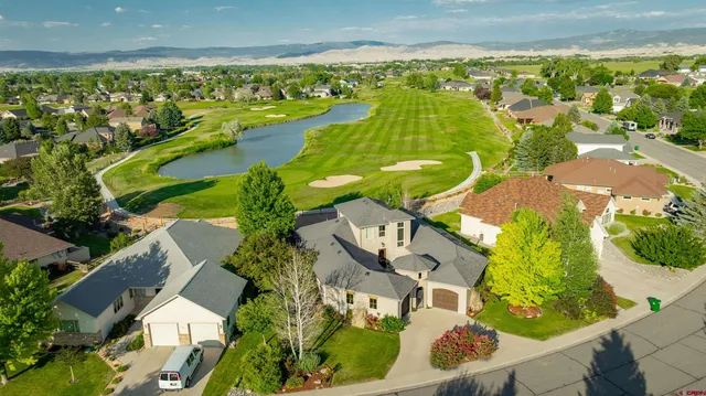 an aerial view of residential houses with outdoor space and swimming pool