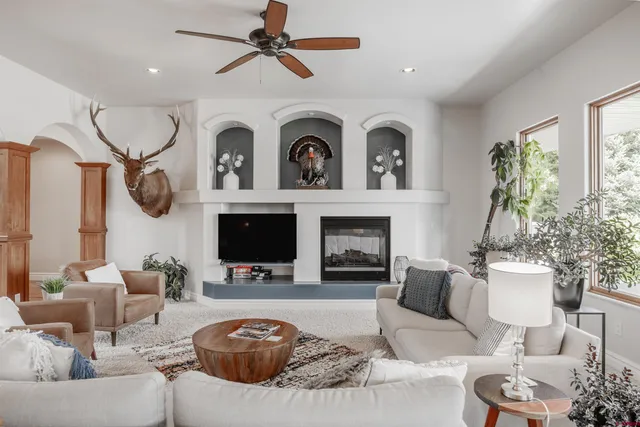 a living room with furniture a flat screen tv and a fireplace