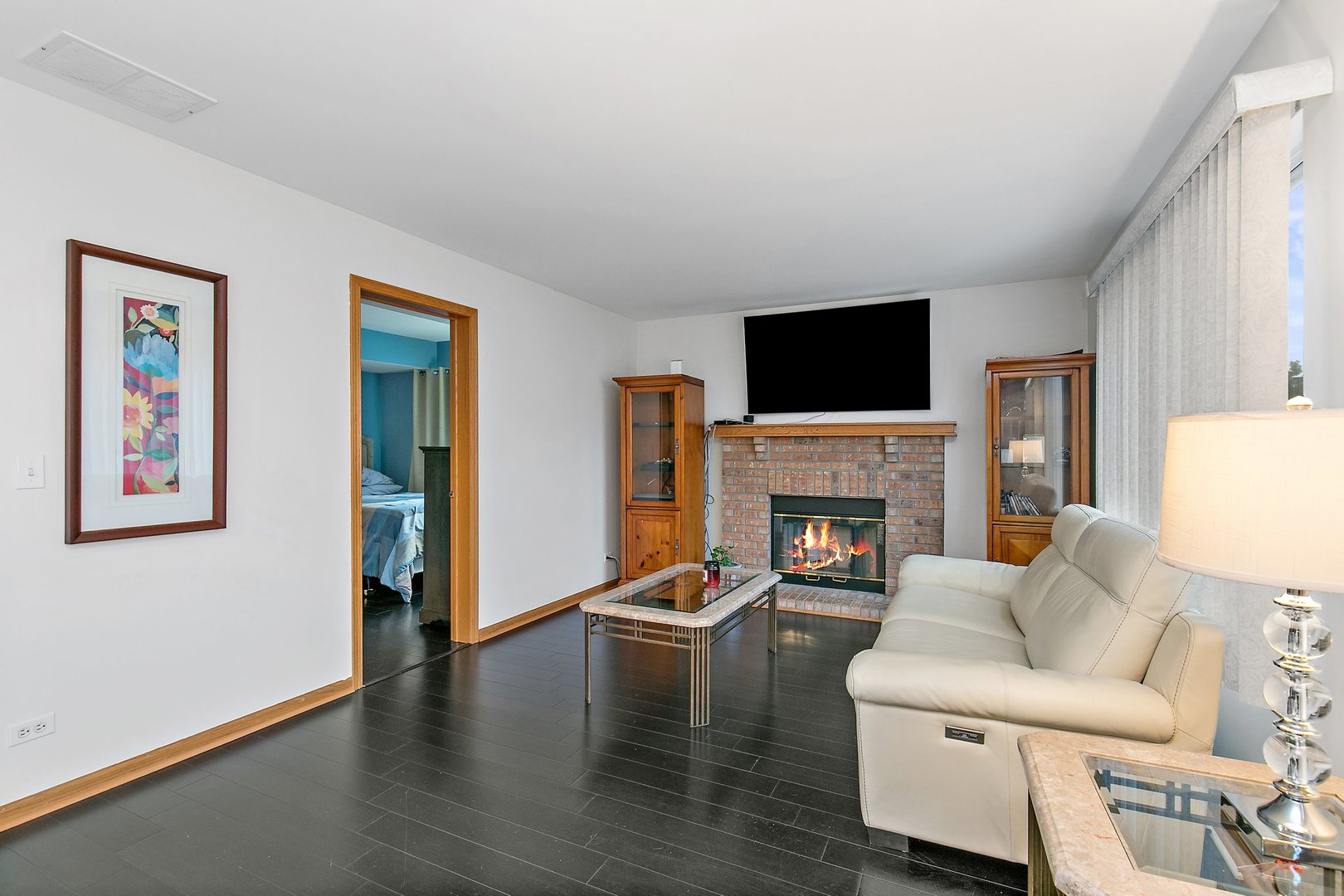 25649 Brooks Farm Road Round Lake, IL 60073 - Photo 11 of 24 a living room with furniture a fireplace and a flat screen tv