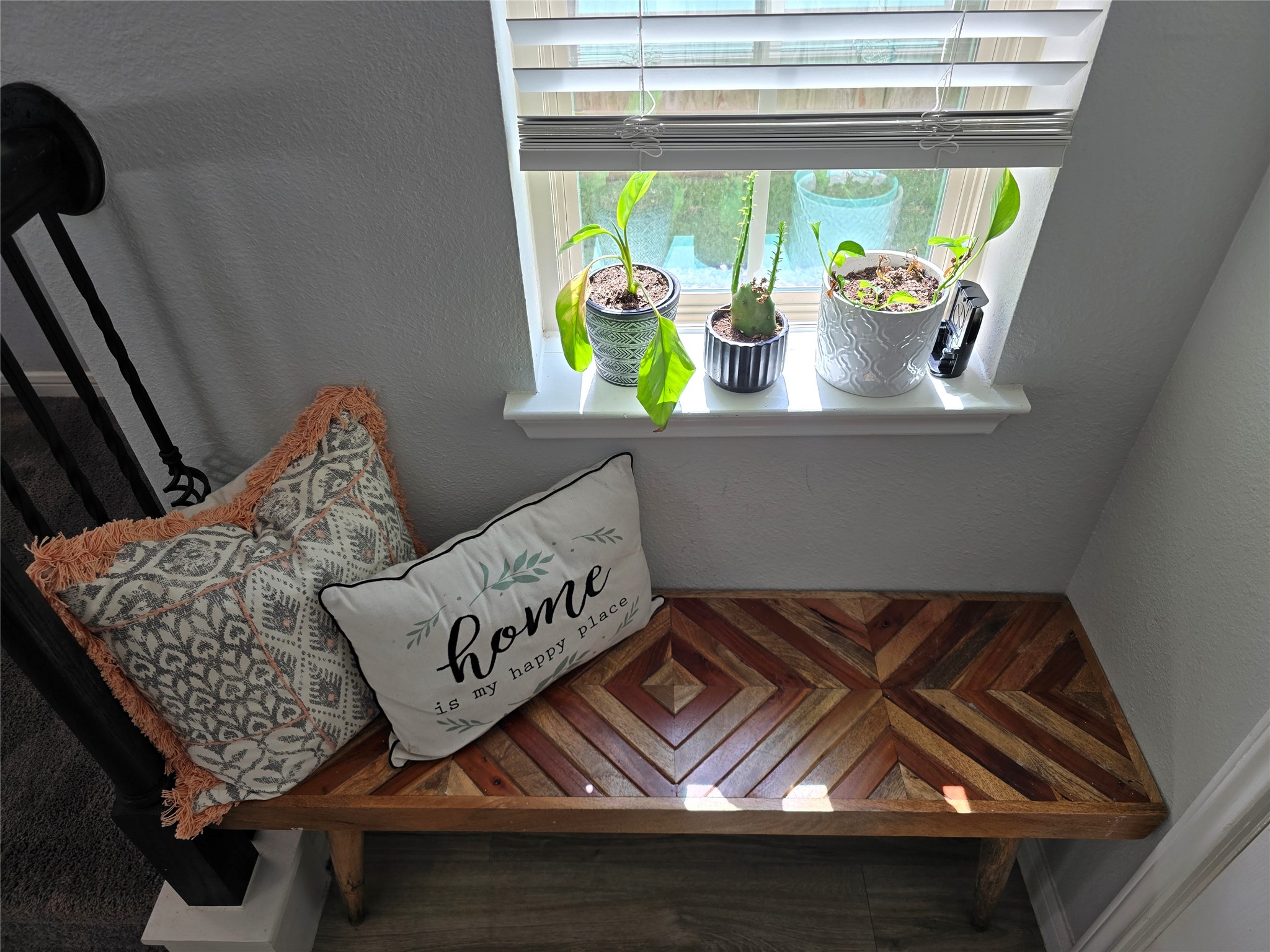 1942 Bending Green Drive Rosharon, TX 77583 - Photo 2 of 30 Cozy nook featuring a wooden bench with decorative cushions and houseplants on a windowsill, providing a warm, inviting space with natural light.