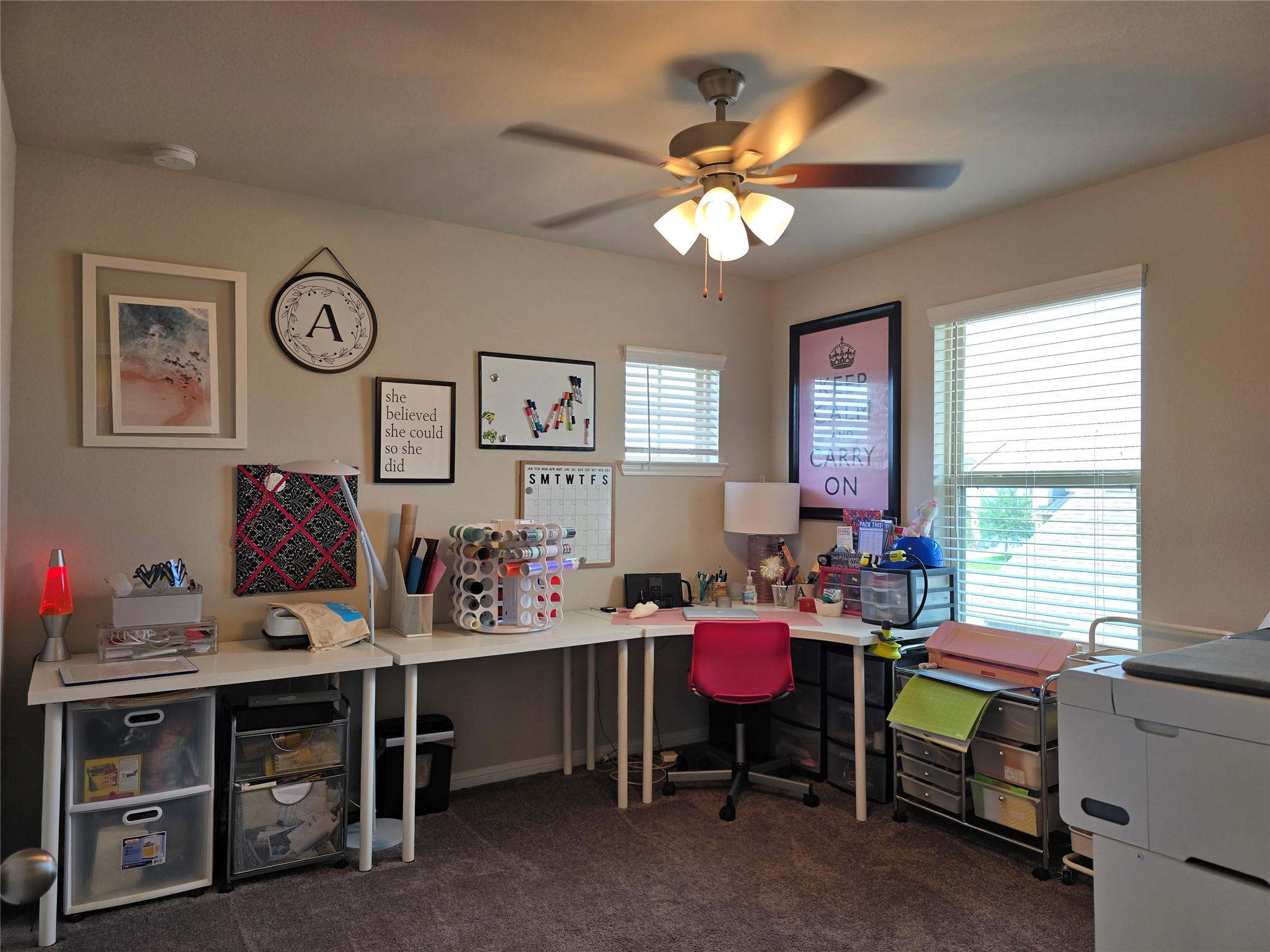 1942 Bending Green Drive Rosharon, TX 77583 - Photo 26 of 30 Bright and functional home office with ample desk space, organized storage, and decorative wall art. Features a ceiling fan and large windows for natural light.