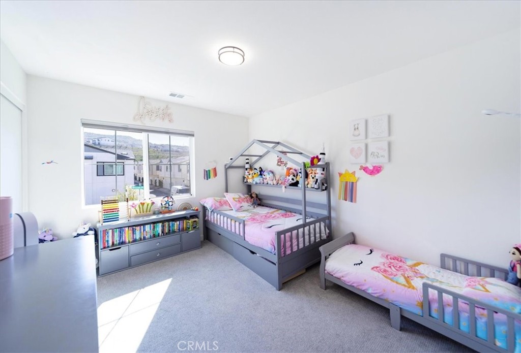 35246 Blossom Place Fallbrook, CA 92028 - Photo 26 of 62 a bedroom with baby bed and a window