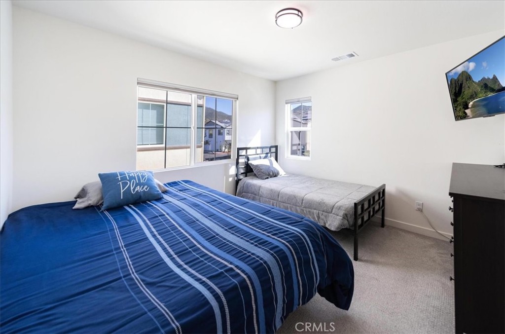 35246 Blossom Place Fallbrook, CA 92028 - Photo 32 of 62 a bedroom with a bed and flat screen tv