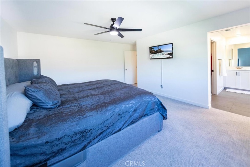 35246 Blossom Place Fallbrook, CA 92028 - Photo 39 of 62 a spacious bedroom with a bed and a ceiling fan