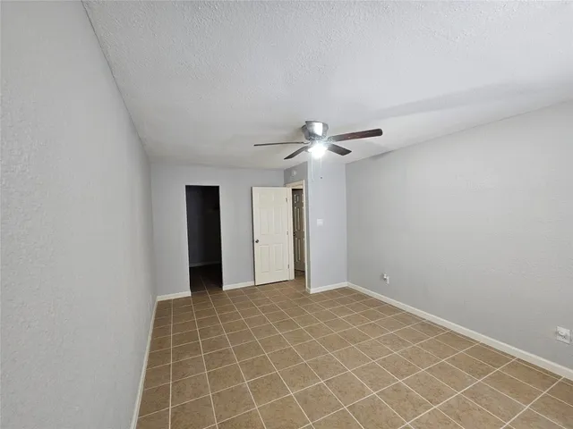 a view of an empty room with a fan
