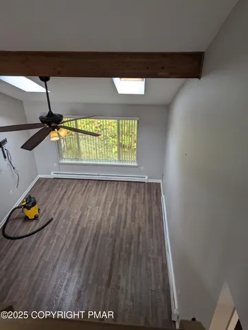 a view of room with wooden floor