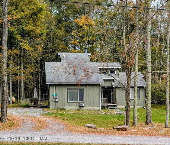 a view of a house with a patio and a yard