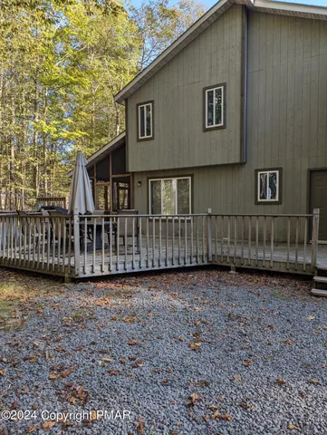 a view of a house with backyard and fence