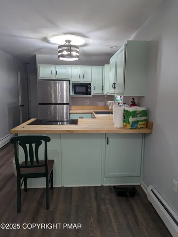 a kitchen with kitchen island a cabinets counter space and a dining table