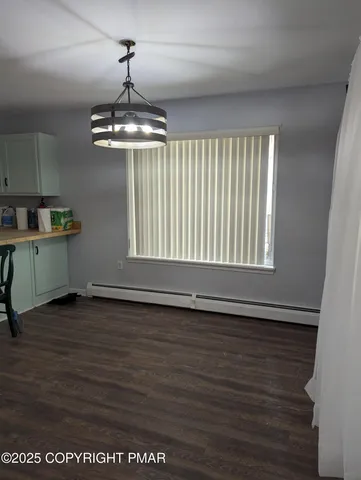 a view of a livingroom with a dishwasher cabinets and a window