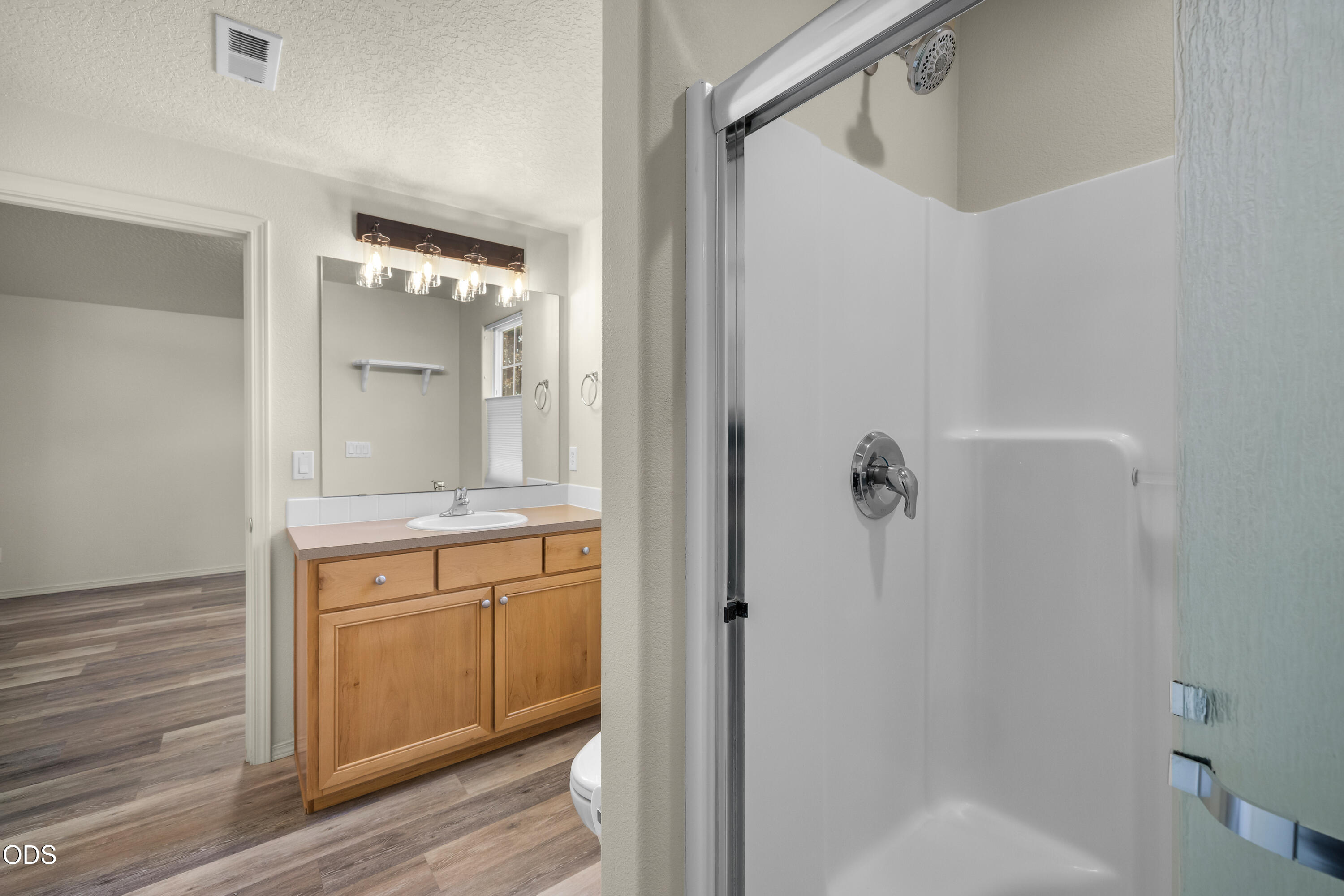 20535 Sunderland Way Bend, OR 97701 - Photo 24 of 41 a bathroom with a granite countertop sink a mirror and a shower