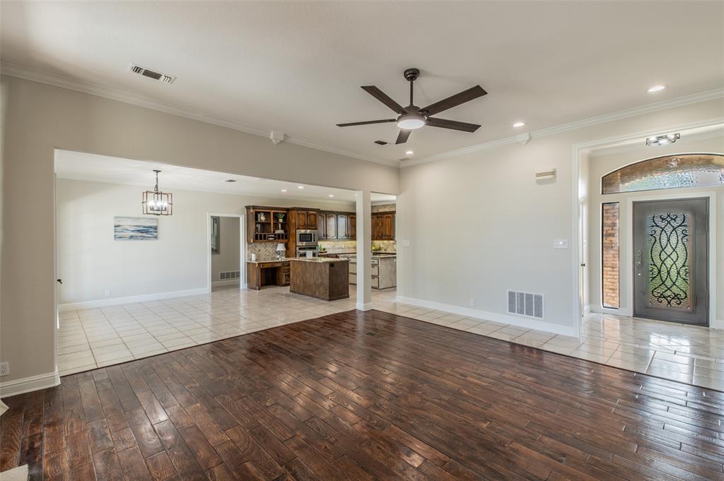 13507 Friendship Road Pilot Point, TX 76258 - Photo 7 of 39 a view of a livingroom with wooden floor and a ceiling fan