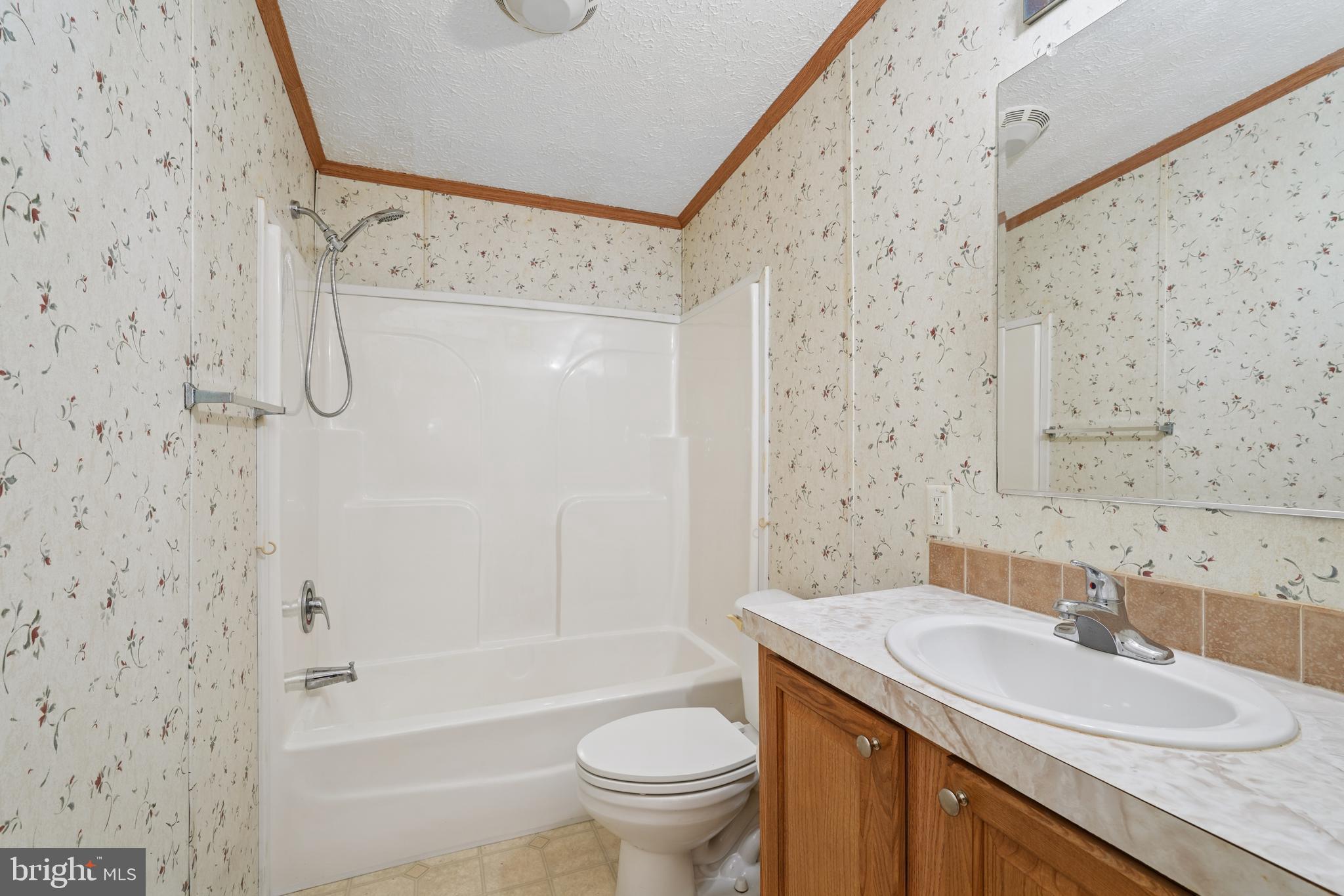 41 North Dragon Drive Bear, DE 19701 - Photo 21 of 30 a bathroom with a granite countertop sink a toilet and a bathtub