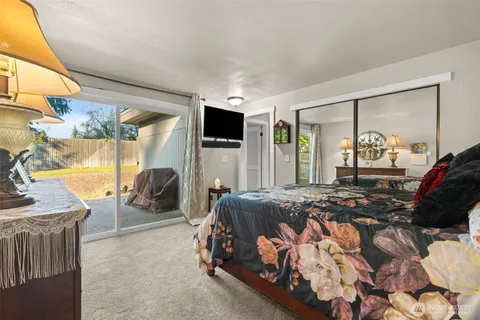 a bedroom with furniture and a large window