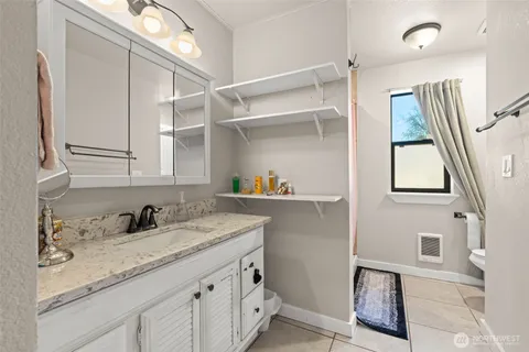 a kitchen with a sink a cabinets and window