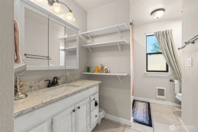 a kitchen with a sink a cabinets and window
