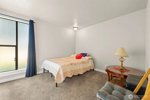 a bedroom with furniture and a window