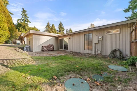 a backyard of a house with yard and outdoor seating