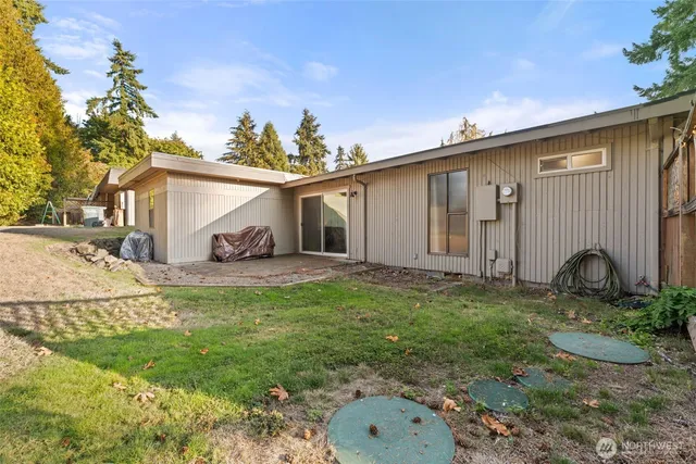 a backyard of a house with yard and outdoor seating