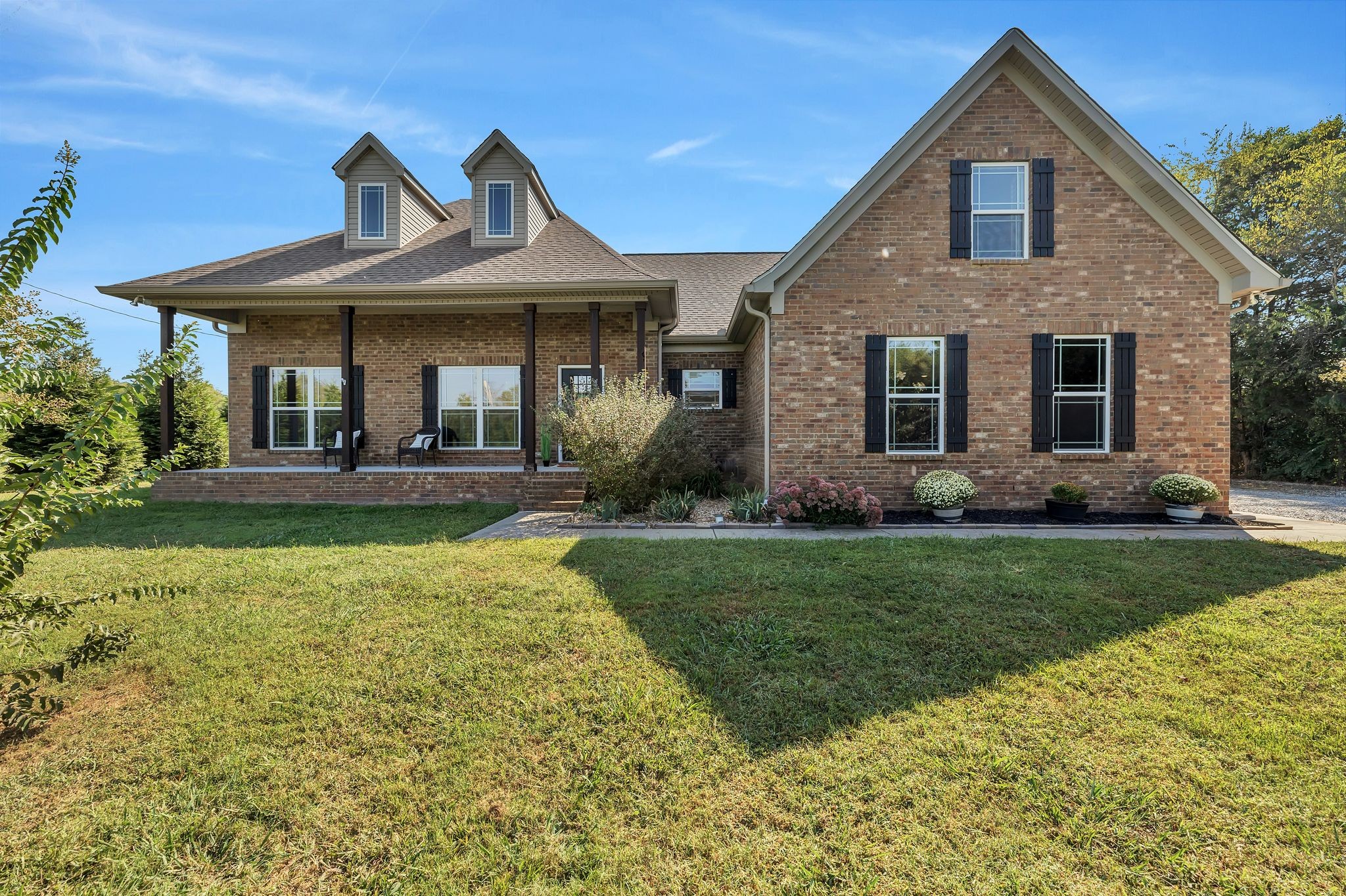 a front view of a house with garden
