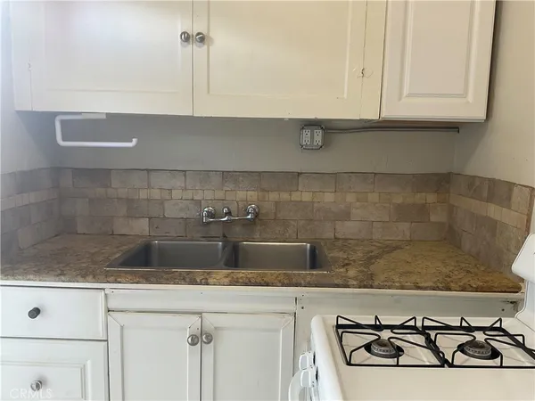 a kitchen with a stove and a refrigerator